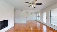 This 1-bedroom, 1-bathroom residence offers a thoughtfully designed layout that maximizes its compact footprint. The open living and dining area is defined by warm terracotta tile flooring that extends throughout the main living spaces, complemented by bright white walls and a ceiling fan that enhance the airy atmosphere. A white brick wood-burning fireplace serves as a standout focal point in the living room, adding both character and warmth. Large sliding glass doors lead to a private balcony overlooking a resort-style pool and courtyard, providing an inviting outdoor view and abundant natural light.

The kitchen is well-equipped with dark espresso cabinetry, granite countertops, stainless steel appliances including a refrigerator, range, and microwave, and a peninsula with a built-in sink that opens toward the living and dining area. Track lighting illuminates the workspace efficiently.

The bedroom is a comfortable retreat featuring warm hardwood-style flooring, a ceiling fan, and multiple windows that invite natural light. A dedicated closet and a full bathroom with dark cabinetry, granite counters, and a tiled tub-shower combination complete the private quarters. The overall design blends classic and contemporary elements for a cohesive, functional living space.