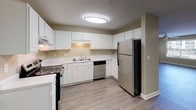 This single-story, 2-bedroom, 2-bathroom residence offers a thoughtfully designed layout with consistent, modern finishes throughout. Warm-toned, neutral walls complement rich hardwood-style flooring that flows seamlessly across the living areas and bedrooms, creating a cohesive and inviting atmosphere.

The spacious living area features a ceiling fan with light fixture and large windows dressed with blinds, filling the space with natural light and views of the outdoors. An open passage connects the living area to additional rooms, enhancing the sense of flow throughout the home.

The kitchen is well-equipped with white cabinetry, light countertops, a double-basin sink, and stainless steel appliances including a refrigerator and dishwasher. Light-toned flooring and a flush ceiling light keep the kitchen bright and functional.

Both bedrooms offer comfortable proportions, with hardwood-style flooring, neutral walls, and windows that bring in natural light. One bedroom includes a ceiling fan, while the other features a flush-mount light fixture.

The two bathrooms are clean and functional, each featuring a tub-shower combination with chrome fixtures, a vanity with a light countertop, and hardwood-style flooring. One bathroom includes additional built-in cabinetry for storage, while the other offers a wide vanity mirror and ample counter space.