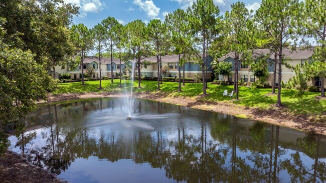 Enjoy the relaxing sounds of the fountain and the serene beauty of nature, right outside your door at Harper Grand. - Harper Grand Apartments