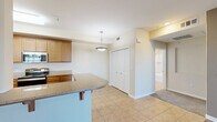 Located at 2000 Villa Dr in Pittsburg, CA, this one-bedroom, one-bathroom unit offers a well-designed single-floor layout with a comfortable and functional living experience. The open-concept kitchen and living area form the heart of the home, with rich hardwood-style flooring in the living space and tile in the kitchen. The kitchen is equipped with warm wood cabinetry, granite-style countertops, stainless steel appliances including a range and dishwasher, and a peninsula breakfast bar with pendant lighting — ideal for both cooking and casual dining. The living room is bright and airy, featuring a ceiling fan and sliding glass doors that lead to a private balcony, allowing natural light to fill the space. The bedroom is a comfortable retreat with plush carpeting, a tray ceiling, ceiling fan, and direct access to a spacious walk-in closet outfitted with wire shelving for ample storage. The full bathroom features warm wood vanity cabinetry, a large mirror with Hollywood-style lighting, a tub and shower combination, and tile flooring. Throughout the unit, neutral tones and clean finishes create a cohesive and inviting ambiance.