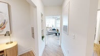 Located at 200 Brooklawn St in Farragut, TN, this well-appointed 2-bedroom, 2-bathroom single-story home offers a thoughtfully designed open-concept layout. Light hardwood flooring flows throughout, complemented by crisp white walls and an abundance of natural light. The hallway entry features built-in shelving niches, leading seamlessly into the main living area, where large windows, a ceiling fan, and a bright, airy ambiance create an inviting atmosphere. The kitchen is a standout, showcasing white shaker cabinetry, a marble-style tile backsplash, quartz countertops, stainless steel appliances, pendant lighting, and a central island. The adjacent dining area is bathed in natural light from a large window with outdoor views. Both bathrooms feature elongated white vanities with quartz counters, modern hardware, and hardwood-style flooring. The primary bedroom is generously sized, offering dual windows with outdoor views and a ceiling fan, while the second bedroom is equally comfortable with ample natural light. A dedicated laundry room houses a full-size side-by-side washer and dryer with overhead shelving. Two closets and three hallways round out this efficiently designed and elegantly finished home.