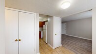 Located at 2010 E Page St in Springfield, Missouri, this single-story, 2-bedroom, 1-bathroom residence offers a practical and well-organized layout across a compact, efficiently designed floor plan. Throughout the home, textured ceilings and neutral warm-beige walls create a consistent, understated aesthetic.

The living room is a bright, open space featuring light-toned luxury vinyl plank flooring and natural light streaming through a window dressed with horizontal blinds. The kitchen is equipped with warm wood cabinetry, granite-style countertops, a gas range, and a full-size refrigerator, with tile flooring tying the space together. A hallway connects the main living areas to the private quarters.

The primary bedroom is a generously sized room featuring plush carpeting, a ceiling fan with light fixture, a window with blinds, and access to a closet. The second bedroom also features LVP flooring and a bright window, offering a clean and versatile space. Both bedrooms share access to the full bathroom, which includes a tiled tub-shower combination, tile flooring, and a toilet. A dedicated laundry area adds everyday convenience. The home also includes two hallways that help define the flow between the living and sleeping areas.