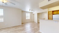 Located at 12845 Frederick St in Moreno Valley, CA, this single-floor, 2-bedroom, 1-bathroom unit offers a well-designed layout across a comfortable footprint. Light wood-style flooring runs consistently throughout, giving the space a clean, cohesive look.

The open living room and kitchen area form the heart of the home. The living room benefits from a ceiling fan and a large window fitted with blinds, allowing natural light to fill the space. The kitchen is efficiently arranged in a U-shaped layout, featuring light wood cabinetry with ample upper and lower storage, a full suite of white appliances including a refrigerator, range, over-the-range microwave, and dishwasher, as well as a stainless steel sink.

Both bedrooms are well-proportioned, with the primary bedroom offering generous square footage, a ceiling fan, and a window overlooking greenery outside. Each bedroom is served by its own dedicated closet, both featuring wire shelving systems that maximize storage capacity.

The bathroom is neatly appointed with a long vanity, quartz-style countertop, dual mirrors, and warm overhead lighting. A hallway connects the bedroom and bathroom areas, contributing to a functional and organized floor plan. Warm neutral wall tones and consistent flooring throughout lend the unit a bright, move-in-ready ambiance.