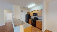 This single-story, 3-bedroom, 2-bathroom residence with a sunroom offers a practical and comfortable layout designed for everyday living. The kitchen is a functional centerpiece, featuring warm honey-toned wood cabinetry, granite countertops, a breakfast bar peninsula, and black appliances including a refrigerator, electric range, built-in microwave, and dishwasher. Durable hardwood-style flooring runs throughout the kitchen and adjoining areas, adding warmth and easy maintenance.

The two bathrooms are finished with tile flooring, granite-topped vanities with wood cabinetry, and chrome fixtures. The full bathroom includes a shower-tub combination, while the second bathroom provides a convenient layout suited for guests or shared use.

Each of the three bedrooms is carpeted and bathed in natural light from windows fitted with horizontal blinds. Ceiling fans with light fixtures are present in the bedrooms, ensuring comfort year-round. The neutral, light-toned walls throughout create a bright and airy atmosphere. The addition of a sunroom further extends the living space, offering an ideal spot to enjoy natural light. Overall, the home presents a clean, well-maintained environment with consistent finishes throughout.