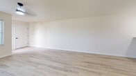 Located at 950 Canter Dr in Madison, WI, this single-floor unit offers a thoughtfully organized layout with one bedroom, two bathrooms, and a combined kitchen and living area. The interior design follows a clean, contemporary aesthetic, characterized by neutral cream-toned walls, light wood-look luxury vinyl plank flooring throughout the main areas, and bright white trim and baseboards.

The open-concept kitchen and living area serves as the heart of the unit. The kitchen features white shaker-style cabinetry with matte black hardware, light-toned countertops, stainless steel appliances including a refrigerator, range, and microwave, and an eat-in peninsula with pendant lighting above. The adjoining living area provides a generous open space with room for flexible furniture arrangements.

The spacious primary bedroom is finished with plush carpet, a ceiling fan with integrated lighting, and a window that allows natural light and neighborhood views. Two bathrooms serve the unit; one includes a full tub-and-shower combination, a white vanity with black hardware, and light flooring consistent with the rest of the unit. A dedicated closet and convenient bathroom adjacency add to the bedroom's functionality. The overall ambiance is bright, clean, and move-in ready.