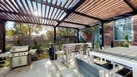 Located at 255 Huguenot St in New Rochelle, NY, this space encompasses a thoughtfully designed outdoor area and a full bathroom. The outdoor patio is anchored by a striking wood-and-metal pergola that filters natural sunlight, creating a comfortable, partially shaded environment. Beneath it, high-top tables and chairs provide a versatile setting for dining or socializing, while lush landscaping, including ornamental grasses and mature trees, frames the perimeter and adds a sense of privacy and greenery. The overall outdoor ambiance is modern yet welcoming, with clean architectural lines complementing the natural surroundings.

The full bathroom is designed with a crisp, contemporary aesthetic. White subway-style tile lines the tub and shower surround, while white floor tiles contribute to a bright, clean feel throughout. The vanity features a white cabinet base with a smooth countertop and an integrated sink, paired with a large mirror and accent lighting. Chrome fixtures add a polished touch. A panel door provides entry, and thoughtful details such as towel bars, decorative wall art, and coordinated accessories give the space a finished, refined look. Together, these areas reflect a commitment to functional design and modern comfort.