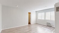 Located at 1253 Havenhurst Dr in West Hollywood, CA, this thoughtfully designed single-floor unit makes excellent use of its intimate footprint. Light hardwood-style flooring runs consistently throughout every room, creating a cohesive and clean aesthetic from entry to bathroom.

The living area is bright and open, featuring soft gray walls, recessed lighting, and a wall-mounted HVAC unit. Multiple windows dressed with white blinds invite generous natural light, lending the space an airy feel. The closet off the main living area provides practical storage with built-in shelving and hanging rods.

The kitchen is well-appointed with white shaker-style cabinetry, brushed nickel hardware, a neutral quartz-style countertop, and a full suite of stainless steel appliances including a gas range, over-the-range microwave, and dishwasher. The layout is compact yet functional, maximizing every inch of available space.

The bathroom offers a clean, modern finish with a white vanity, taupe countertop, undermount sink, and brushed gold fixtures. A full tub and shower combination is tiled in white, complemented by coordinating gold hardware and a mirrored medicine cabinet. The hallway connects the rooms efficiently, and a secondary closet area with sliding doors provides additional storage. The overall ambiance is fresh, minimal, and move-in ready.