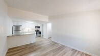 Located at 3108 Keewahdin Rd in Fort Gratiot, MI, this one-bedroom, one-bathroom unit is thoughtfully laid out across a single floor, making efficient use of its compact footprint. Light-toned luxury vinyl plank flooring runs consistently throughout the space, creating a clean, cohesive aesthetic.

The open living area features a wall-mounted PTAC unit for climate control and a large window dressed with vertical blinds that allows natural light to fill the room. It flows directly into the kitchen, which is appointed with white shaker-style cabinetry, granite-look countertops, a stainless steel sink, and a full suite of stainless steel appliances including a refrigerator, range, and microwave. A peninsula counter extends into the living area, providing additional workspace and a casual dining option.

The bedroom is a comfortable size, outfitted with a ceiling fan, a window with an exterior view, and a closet. The bathroom includes a single-vanity with white cabinetry, a toilet, and a full tub-shower combination. A dedicated laundry room houses the water heater and includes washer/dryer hookups. Textured ceilings are present throughout, and clean white walls give the entire unit a bright, well-maintained feel.