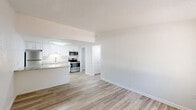 Located at 3108 Keewahdin Rd in Fort Gratiot, MI, this one-bedroom, one-bathroom unit is thoughtfully laid out across a single floor, making efficient use of its compact footprint. Light-toned luxury vinyl plank flooring runs consistently throughout the space, creating a clean, cohesive aesthetic.

The open living area features a wall-mounted PTAC unit for climate control and a large window dressed with vertical blinds that allows natural light to fill the room. It flows directly into the kitchen, which is appointed with white shaker-style cabinetry, granite-look countertops, a stainless steel sink, and a full suite of stainless steel appliances including a refrigerator, range, and microwave. A peninsula counter extends into the living area, providing additional workspace and a casual dining option.

The bedroom is a comfortable size, outfitted with a ceiling fan, a window with an exterior view, and a closet. The bathroom includes a single-vanity with white cabinetry, a toilet, and a full tub-shower combination. A dedicated laundry room houses the water heater and includes washer/dryer hookups. Textured ceilings are present throughout, and clean white walls give the entire unit a bright, well-maintained feel.