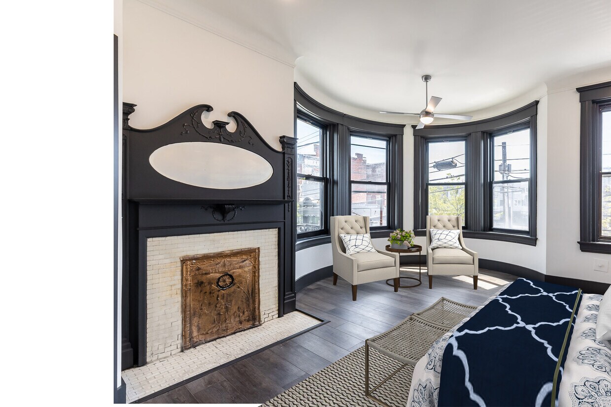 Fusion of historic architecture and cool new amenities are highlighted in this primary bedroom - 728 E McMillan St