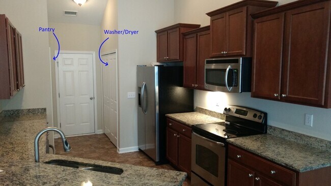 Well-appointed kitchen with granite countertops and stainless steel appliances - 1604 Fairforest Court