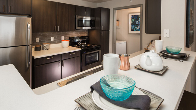 Apartment Kitchen with Stainless Steel Appliances and quartz counters. - Griffis Lafayette Station