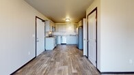 This single-floor unit in the Countryside neighborhood of Rapid City, South Dakota, offers a practical and well-organized layout designed for comfortable everyday living. The kitchen serves as a functional centerpiece, featuring white cabinetry, granite-look countertops, wood-look plank flooring, and a full suite of stainless steel appliances including a refrigerator, dishwasher, and microwave. Pendant lighting and flush-mount ceiling fixtures illuminate the space, while multiple doorways provide convenient access to adjoining areas.

The bedrooms are carpeted and finished with neutral tones, creating calm and versatile spaces. Each room benefits from natural light provided by windows with blinds, and several include closets for storage. Dark-trimmed door frames add a subtle contrast to the light walls throughout.

Two full bathrooms serve the unit, each equipped with a tub-shower combo, toilet, and vanity with granite-look countertops. Wood-look tile flooring in the bathrooms complements the overall aesthetic of the home.

Dark baseboards and door trim provide a consistent design element throughout, tying together the unit's clean, contemporary look. The floor plan, as seen in the 3D overview, reflects a well-proportioned layout suited for a variety of living arrangements.