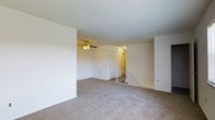 Located at 500 Chews Landing Road in Lindenwold, New Jersey, this residential space offers a clean and functional layout designed for comfortable everyday living. The main living area is finished with wall-to-wall plush carpeting that adds warmth and softness underfoot, while the white walls and smooth ceilings contribute to a bright, airy atmosphere throughout. A ceiling fan with an integrated light fixture is centrally mounted, providing both airflow and ambient lighting to the space. A white metal stair railing is visible, indicating access to an additional level and adding a subtle architectural detail to the open floor plan. A closet door and interior doorway are also present, offering practical storage and room connectivity. The overall design is neutral and understated, creating a versatile canvas well-suited for a variety of furnishing and décor styles. The space's straightforward layout and clean finishes make it an accessible and move-in ready option in the Lindenwold community of Camden County, New Jersey.