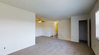 Located at 500 Chews Landing Road in Lindenwold, New Jersey, this residential space offers a clean and functional layout designed for comfortable everyday living. The main living area is finished with wall-to-wall plush carpeting that adds warmth and softness underfoot, while the white walls and smooth ceilings contribute to a bright, airy atmosphere throughout. A ceiling fan with an integrated light fixture is centrally mounted, providing both airflow and ambient lighting to the space. A white metal stair railing is visible, indicating access to an additional level and adding a subtle architectural detail to the open floor plan. A closet door and interior doorway are also present, offering practical storage and room connectivity. The overall design is neutral and understated, creating a versatile canvas well-suited for a variety of furnishing and décor styles. The space's straightforward layout and clean finishes make it an accessible and move-in ready option in the Lindenwold community of Camden County, New Jersey.