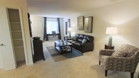 Located at 201 Treybrooke Dr in Morrisville, NC, this single-floor residence offers a thoughtfully designed living space that balances comfort and functionality. The living room serves as the centerpiece of the home, featuring plush wall-to-wall carpeting that adds warmth underfoot throughout the space. Neutral-toned walls provide a versatile backdrop, complementing a range of furnishing styles. A large window dressed with decorative curtains allows natural light to fill the room, creating a bright and inviting atmosphere. The layout is generously proportioned, providing ample room for seating arrangements and everyday living. A front entryway with a classic paneled door offers a clean transition into the main living area. The space is further enhanced by recessed nook areas that can serve as dedicated workspaces or reading corners, adding to the overall versatility of the floor plan. The open feel of the living area, combined with soft lighting and carefully considered design details, contributes to an atmosphere that is both practical and comfortable. Overall, this single-level home in Morrisville presents a well-maintained and move-in-ready environment suited for a variety of lifestyles.