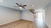 Located at 3115 Carroll Rd in Fort Wayne, Indiana, this two-story home offers 3 bedrooms and 3 bathrooms across a thoughtfully designed layout. The main floor features a spacious living room with warm wood-look LVP flooring, a ceiling fan with integrated lighting, recessed lights, and neutral gray walls that create a clean, modern aesthetic. A staircase connects to the upper level, and natural light filters in through sliding glass doors at the rear of the main floor.

The kitchen is a standout feature, showcasing dark cabinetry, granite-style countertops, stainless steel appliances, and LVP flooring — a functional and stylish space for everyday use. A dedicated laundry area houses a stacked washer and dryer unit for added convenience.

Upstairs, the three bedrooms are carpeted and well-lit, each with windows that bring in natural light. The generously sized primary bedroom includes a closet and direct access to an adjoining bathroom. The bathrooms throughout feature tub-shower combinations with clean white surrounds, wood-look flooring, and simple, durable finishes.

The home also includes hallways connecting key areas, a dedicated closet, and a practical overall flow that makes efficient use of every square foot across both floors.