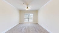 Located in Jersey Village, TX, this single-floor, one-bedroom, one-bathroom residence offers a well-organized and efficient layout. The kitchen greets you at the entry and features rich cherry wood cabinetry, granite-style countertops, a double-basin sink, and white appliances including a range, dishwasher, and refrigerator. Light tile flooring runs through the kitchen and entry areas, creating a clean, practical foundation. The open transition from the kitchen leads into a comfortable living area carpeted in neutral tones, brightened by natural light from multiple windows dressed with horizontal blinds. Crown molding and ceiling fans with integrated lighting are present throughout, adding a refined touch to the interiors. The bedroom is a well-sized, carpeted retreat featuring a ceiling fan, crown molding, a closet with louvered doors, and a window offering outdoor views. A hallway connects the main living spaces to the full bathroom, which includes a vanity with cherry wood cabinetry, a granite-style countertop, tile flooring, and a tub-shower combination. The overall ambiance is bright, clean, and functional, making this a well-rounded and comfortable living space.