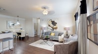 Located at 2000 Broadstone Way in Apex, NC, this thoughtfully designed single-floor residence offers a cohesive blend of modern style and everyday comfort. The open-concept living area serves as the heart of the home, showcasing rich hardwood-style flooring, crown molding, and generous natural light streaming through large windows dressed with elegant draping. The space flows seamlessly into a separate dining area, making it well-suited for both relaxed living and entertaining.

The kitchen is outfitted with dark espresso cabinetry, granite-style countertops, and a full suite of stainless steel appliances. A breakfast bar provides additional seating and connects the kitchen to the adjacent living and dining spaces.

The bedrooms offer a calm retreat, featuring plush carpeting, ample natural light, and ceiling fixtures. The primary bedroom is generously proportioned and includes windows that invite in soft daylight.

The bathroom features a dark wood vanity with a granite-style countertop, a large mirror, and tile flooring, combining functionality with a clean, polished aesthetic.

Throughout the residence, a neutral color palette and consistent design details create a warm, inviting ambiance that is both sophisticated and livable.