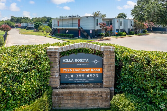 Villa Rosita Entrance Drive – Gated community entry with monument sign and manicured greenery. - Villa Rosita