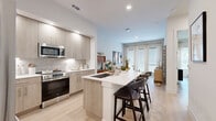 This well-designed one-bedroom, one-bathroom residence in San Antonio, Texas offers a thoughtfully planned single-floor layout that maximizes every square foot. The open-concept living and kitchen area serves as the heart of the home, anchored by a sleek kitchen featuring light wood cabinetry that extends to the ceiling, white quartz countertops, stainless steel appliances, and a generously sized island with bar seating — ideal for casual dining and entertaining. Light wood-look flooring runs throughout the main living spaces, complementing the clean, neutral palette and recessed lighting that keep the interior feeling bright and airy. Large windows dressed with sheer curtains allow natural light to pour into the living area, creating an open and welcoming ambiance. The bedroom offers a comfortable and serene retreat, with windows providing ample natural light and views of the surrounding greenery. The space accommodates a full suite of bedroom furnishings and includes a dedicated closet for storage. A full bathroom and additional utility spaces complete the floor plan. The overall design aesthetic is modern and cohesive, blending contemporary finishes with functional layouts to create a comfortable, move-in-ready living environment in the South San Antonio area.