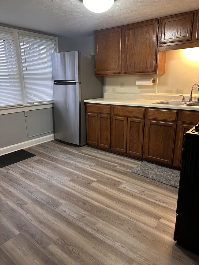Solid oak kitchen cabinets with over the sink light. - 1841 E 5th St