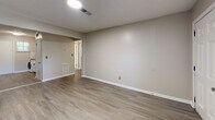 Located in Smyrna, Georgia, this 2-bedroom, 1-bathroom residence offers a thoughtfully designed single-floor layout with modern updates throughout. Wood-look luxury vinyl flooring flows consistently across the living areas, hallway, and bedrooms, creating a cohesive and easy-to-maintain aesthetic.

The open living room is bright and welcoming, featuring neutral walls, a window with natural light, and direct sight lines into the kitchen. The kitchen is well-equipped with white shaker cabinetry with matte black hardware, dark granite countertops, a classic white subway tile backsplash, a stainless steel sink with a matte black faucet, and a dishwasher. A black refrigerator and range complete the space, alongside a washer tucked neatly within the kitchen area, providing in-unit laundry convenience. A pantry offers additional storage.

The hallway connects the living areas to the two bedrooms and bathroom, offering a clean and organized transition. Both bedrooms feature ceiling fans with lighting, windows for natural light, and closets. The primary bedroom includes a sliding closet and connects conveniently to the hallway. Three closets total provide ample storage throughout.

Additional highlights include a patio, a utility room, and a neutral color palette throughout that creates a calm, move-in-ready ambiance.