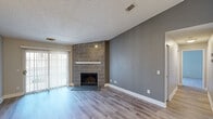 Located at 1517 Weymouth Cir in Westlake, Ohio, this 2-bedroom, 1-bathroom home offers a well-designed single-floor layout that maximizes every square foot of living space. The living room serves as the heart of the home, immediately drawing attention with its floor-to-ceiling tile-surround fireplace topped with a sleek white mantle shelf. Light wood-style flooring runs throughout the main living areas, complementing the neutral gray walls and crisp white baseboards. A sliding glass door floods the living room with natural light, adding an airy, open feel to the space. The galley-style kitchen is thoughtfully outfitted with rich dark cabinetry, light countertops, stainless steel appliances, and wood-style flooring, with a convenient passthrough to the hallway. The full bathroom features dark wood vanity cabinetry, a framed mirror, light countertops, and a tub-shower combination. The primary bedroom is a comfortable size, complete with hardwood-style flooring and a ceiling fan with light fixture, while the second bedroom offers plush carpeting and a clean, neutral palette. Textured ceilings are found throughout, adding a classic finishing touch to this move-in ready home.
