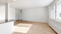 Located at 739 Birchmount Road in Toronto's Scarborough neighbourhood, this well-appointed one-bedroom, one-bathroom unit offers a clean, modern aesthetic throughout. The open-concept layout connects the living, dining, and kitchen areas into a cohesive and functional space. Light hardwood flooring runs throughout the main living areas, complemented by crisp white walls that enhance the sense of brightness and openness.

The kitchen is a standout feature, equipped with stainless steel appliances including a full-size refrigerator, electric range, built-in microwave, and dishwasher. White cabinetry provides ample storage, while dark countertops offer a sharp contrast. Glossy tile flooring transitions seamlessly into the kitchen zone, visually separating it from the living area.

Large windows in both the living room and bedroom allow generous natural light to fill the space, with baseboard heating units running along the walls. The bedroom is a comfortable size, featuring mirrored sliding closet doors and its own window. A dedicated closet provides additional storage.

The bathroom is finished with classic white subway tile surrounding the soaker tub and shower, a dark vanity, and neutral floor tiles, creating a timeless and clean look. Overall, this unit delivers a bright, functional, and well-maintained living environment.