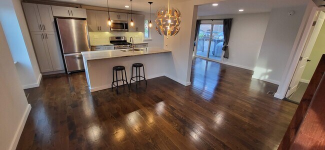 Dining Area with Kitchen and LR in background - 121 Trolley Crossing Ln