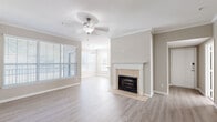 Located in Savannah, GA, this single-story, three-bedroom, two-bathroom home offers a well-designed layout with comfortable living spaces throughout. The open living and dining area serves as the heart of the home, featuring light wood-style flooring, crown molding, a ceiling fan, and a classic tile-surround fireplace with a white mantle as a focal point. Abundant natural light streams in through plantation-shuttered windows, creating a bright and welcoming atmosphere. The kitchen is equipped with white shaker cabinetry, stone-look countertops, stainless steel appliances including a range and dishwasher, and a peninsula with a double sink. A charming bay window nook in the kitchen area adds additional light and a sense of openness. The spacious primary bedroom includes a ceiling fan and ample room, while the additional bedrooms feature plush carpeting, ceiling fans, and windows with blinds. The bathrooms are finished with stone-look countertops, white vanity cabinetry, large mirrors, and a tiled tub-shower combo. Throughout the home, neutral warm-gray tones create a cohesive, move-in-ready aesthetic well-suited to Savannah's welcoming character.