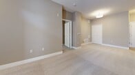 This contemporary apartment in Omaha, NE offers 1030 square feet of well-designed living space on a single floor. The layout includes two bedrooms, three bathrooms, a combined kitchen and living area, and two closets. The primary bedroom is generously sized at 150 square feet, providing ample space for comfort.

The gourmet kitchen is a standout feature, boasting rich wood cabinetry, stainless steel appliances, and elegant granite countertops. A unique wine rack above the cabinets adds a touch of sophistication. The kitchen's hardwood flooring seamlessly transitions to plush carpeting in the living areas and bedrooms, creating a cohesive yet distinct ambiance throughout the space.

Large windows in the bedrooms and living areas flood the apartment with natural light, while offering privacy through adjustable blinds. The bathrooms feature modern fixtures, including a sleek vanity with a granite countertop and an undermount sink.

The apartment's neutral color palette, with soft beige walls and white trim, provides a versatile backdrop for various decor styles. Track lighting in the kitchen and recessed lighting in other areas ensure well-illuminated spaces. This thoughtfully designed apartment combines functionality with style, offering a comfortable and contemporary living environment in the heart of Omaha.