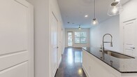 Step into a world where contemporary design meets effortless living. This stunning 680 square foot apartment is your gateway to an elevated urban lifestyle. The moment you enter, you'll be captivated by the seamless blend of style and function.

The heart of this home is the gourmet kitchen, a culinary enthusiast's dream. Boasting sleek stainless steel appliances, chic dark wood cabinetry, and a striking granite countertop, it's perfect for both everyday meals and entertaining. The modern backsplash adds a touch of sophistication, while pendant lighting casts a warm glow over the inviting island.

The spacious living area is bathed in natural light, thanks to large windows that frame picturesque views. Polished concrete floors flow throughout, adding an industrial-chic vibe that's both on-trend and low-maintenance. A ceiling fan ensures year-round comfort, while the open layout allows for endless arrangement possibilities.

The generously sized bedroom, at 130 square feet, offers a serene retreat. It features ample closet space and continues the apartment's theme of abundant natural light. The bathroom is a model of modern elegance, with a expansive vanity, sleek fixtures, and a design that maximizes space and functionality.

This apartment isn't just a living space; it's a lifestyle choice. The in-unit laundry adds convenience to your daily routine, while the overall design speaks to those who appreciate contemporary aesthetics and smart living solutions. Whether you're a young professional, a design enthusiast, or someone looking to simplify without sacrificing style, this apartment offers the perfect blend of comfort, sophistication, and urban convenience. Welcome home to your personal sanctuary in the heart of the city.