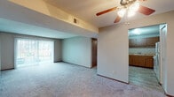 Located at 4014 W Hollow Creek Dr in Peoria, Illinois, this single-floor residence offers a well-organized layout designed for comfortable everyday living. The open living area is a standout feature, highlighted by plush carpeting, a ceiling fan with integrated lighting, and a textured ceiling that adds subtle visual interest. Vertical blinds frame a sliding glass door, allowing natural light to fill the space while providing access to the outdoors. The kitchen is efficiently designed with warm wood-toned cabinetry extending to the upper walls, a double-basin sink, light countertops in an L-shaped configuration, a dishwasher, and a range, all set atop easy-care hard-surface flooring. The bedrooms are generously proportioned, each featuring soft carpeting, ceiling fans, and windows that bring in natural light and outdoor views of the surrounding neighborhood. The full bathroom is clean and functional, offering a combined tub and shower with grab bar, a single vanity with wood cabinetry, and hard-surface flooring that complements the rest of the home. Throughout the residence, neutral tones and consistent finishes create a cohesive and practical living environment suited for a variety of lifestyles.