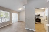 Located at 3365 Pinewalk Dr N in Margate, FL, this one-bedroom, one-bathroom residence offers a well-organized single-floor layout designed for comfortable everyday living. The open-concept living and dining area is finished with light wood-style flooring and neutral gray tones throughout, creating a bright and airy atmosphere. Large windows and a sliding glass door flood the space with natural light while offering views of lush greenery and a community pool beyond. A ceiling fan adds to the comfort of the living area.

The kitchen is thoughtfully appointed with white shaker-style cabinetry, granite-look countertops, a stainless steel sink, and a full suite of stainless steel appliances including a range and over-the-range microwave. Light wood flooring continues through the kitchen, tying the common areas together seamlessly.

The bedroom is a well-proportioned retreat featuring plush carpeting, vertical blinds, and a window that brings in ample natural light. A hallway connects the main living areas and provides access to a closet with louvered doors.

The bathroom is well-equipped with a dual-sink vanity topped with granite-style counters, white cabinetry, a large mirror, and a separate shower and toilet area. Wood-look flooring completes the clean, contemporary finish of this functional and inviting home.