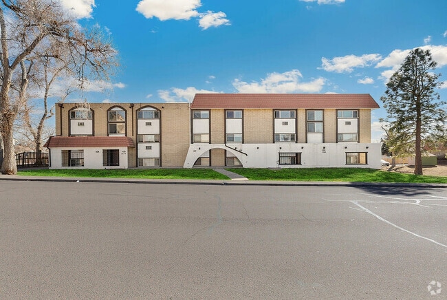 Charming apartment building with modern architecture, featuring large windows and scenic views. - Country Club