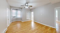 Located at 1121 Spruce St, Unit 3A in Philadelphia's vibrant Washington Square West neighborhood, this one-bedroom, one-bathroom unit offers a well-organized and efficient layout across a single floor. Warm hardwood flooring flows throughout the living and sleeping areas, lending a cohesive and inviting feel to the space.

The living room is a comfortable and airy retreat, featuring a ceiling fan with integrated lighting, recessed lighting, and a charming arched entryway that adds architectural character. A built-in shelving nook provides practical storage and display space, while natural light filters in through multiple windows. A baseboard heating system runs along the perimeter walls.

The bedroom continues the hardwood flooring and neutral gray tones, offering a calm and restful atmosphere. A set of bi-fold closet doors provides ample storage, and a ceiling fan keeps the room comfortable year-round.

The kitchen is compact and functional, equipped with warm oak cabinetry, light blue countertops, a coil-top electric range, and a full-size refrigerator. Tile flooring and under-cabinet ventilation complete the practical setup.

The bathroom is clean and bright, finished in white tile flooring with a tiled shower stall and overhead cabinetry for storage. Natural light from a frosted window enhances the crisp, airy feel of the room.