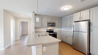 Located at 4691 Hall Rd in Columbus, Ohio, this single-floor, three-bedroom, one-bathroom home offers a clean, modern design with a bright, cohesive aesthetic throughout. Light-toned luxury vinyl plank flooring runs continuously across the entire home, lending a sense of warmth and visual continuity.

The open-concept kitchen and living area serves as the heart of the home. The kitchen is outfitted with gray shaker-style cabinetry, granite-look countertops, a peninsula with pendant lighting, and a full suite of stainless steel appliances including a refrigerator, electric range, and over-the-range microwave. The adjacent living room receives generous natural light through large windows and a glass exterior door, and features a ceiling fan overhead.

Three bedrooms offer comfortable, well-lit spaces, each with windows fitted with horizontal blinds. The primary bedroom includes a walk-in closet with multi-level wire shelving for organized storage. Additional closets throughout the home provide further storage flexibility.

The full bathroom includes a tub-shower combo, a single-sink vanity with shaker-style cabinetry, and hardwood-look flooring. A dedicated laundry room with washer and dryer hookups adds everyday convenience. The home's neutral color palette, modern finishes, and functional layout make it a practical and inviting living space.