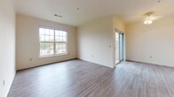 Located at 270 Brandywine Dr in Bear, Delaware, this single-floor residence offers a well-organized layout with a clean, neutral palette throughout. The entry is distinguished by a graceful arched passageway that leads into the main living area, where light-toned hardwood-style flooring extends across an open, airy space filled with natural light from large multi-pane windows. Sliding glass doors provide access to an outdoor area, enhancing the sense of openness in the living room.

The kitchen is thoughtfully equipped with white cabinetry offering generous storage, dark speckled countertops, a double-basin stainless steel sink positioned beneath a window, and a dishwasher for added convenience. The hardwood-style flooring continues here, maintaining a cohesive aesthetic.

The bedrooms are carpeted for comfort and warmth, each receiving ample natural light through large windows. One bedroom features direct access to a private bathroom, adding a practical ensuite arrangement. Closet space is included in the bedroom areas for organized storage.

The bathroom is finished with full white tile surrounding a soaking tub and shower combination, providing a clean and classic look. Throughout the residence, the warm cream-toned walls, consistent flooring choices, and well-proportioned rooms create a comfortable and inviting living environment.