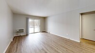 Located at 211 N Lincolnway St in North Aurora, IL, this one-bedroom, one-bathroom unit offers a thoughtfully organized single-floor layout. The entrance leads into a hallway with a louvered closet, opening to the combined living and dining area — a bright, open space highlighted by a sliding glass door that fills the room with natural light and provides access to an outdoor view. A ceiling fan and baseboard heating add comfort to this versatile space.

The kitchen features white upper cabinetry and gray lower cabinets, light countertops, a double-basin sink, and black appliances including a gas range, over-the-range microwave, and refrigerator — offering a functional and efficient cooking space.

The bedroom is a generously sized retreat with a large mirrored sliding-door closet that enhances the sense of space, a window for natural light, and baseboard heating. Additional storage is provided by multiple closets accessible throughout the unit.

The bathroom is clean and well-appointed, featuring a full tub/shower combo with a chrome fixture, a toilet, and a vanity with gray cabinetry. Light wood-look flooring runs consistently throughout the unit, complementing the neutral gray and white color palette for a cohesive, modern aesthetic.