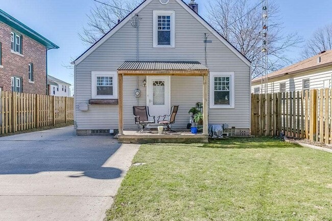 Backyard features fenced yard with covered porch, separate patio, 2 car garage and shed, along with plenty of space for parking - 7021 35th Avenue