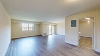 Located at 9909 Cervine Ln in Randallstown, MD, this single-floor, 2-bedroom, 2-bathroom home offers a well-organized and comfortable layout. Consistent hardwood-style flooring flows throughout the entire space, lending a clean, cohesive aesthetic to every room.

The expansive living room is bright and open, bathed in natural light from large windows and a sliding glass door that leads to an outdoor area. A ceiling fan adds both function and character to the space. The layout provides an excellent sense of openness and easy flow between rooms.

The kitchen features warm wood cabinetry, a gas range, full-size refrigerator, and a stainless steel sink, all complemented by the same durable flooring. A ceiling fan overhead keeps the space comfortable.

The generously sized primary bedroom offers ample room and includes two large double-door closets for abundant storage. The second bedroom also benefits from a closet and direct sightlines to the kitchen. A dedicated walk-in closet provides additional storage. Both bathrooms are well-appointed, with one featuring a tiled shower enclosure with sliding glass doors.

A hallway connects the rooms efficiently, and the overall neutral color palette of warm beige tones throughout creates a welcoming and versatile living environment.