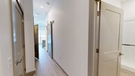 Located at 7207 McKnight Rd in Pittsburgh, PA, this thoughtfully designed one-bedroom, one-bathroom unit offers a clean, modern aesthetic throughout its single-floor layout. Light wood-look flooring flows seamlessly across every room, complementing the crisp white walls and creating a bright, cohesive atmosphere.

The hallway serves as a functional connector between spaces, featuring a stylish barn-style sliding door with brushed metal hardware. It leads to an open living area with a kitchen island boasting a butcher block countertop and slate-blue cabinetry with gold-toned hardware. A balcony door allows natural light to fill the space.

The bedroom is a well-proportioned retreat featuring dual sliding closets with built-in rods and shelving, offering generous storage capacity. Clean white walls and continued light flooring give the room a calm, airy feel.

The bathroom is finished to a high standard, showcasing a frameless glass sliding shower enclosure with white tile surround, a modern elongated toilet, and a sleek vanity with white countertop and taupe cabinetry. The consistent wood-look flooring ties the room together with the rest of the unit.

Overall, this unit presents a contemporary, move-in-ready space with quality finishes and a clean, minimalist design sensibility.