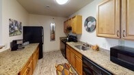 Located at 1212 Christiana Meadows in Bear, Delaware, this single-floor residence offers a thoughtfully designed layout with a comfortable, functional flow throughout. The open-concept living and dining area is anchored by warm hardwood-style flooring, providing a welcoming atmosphere ideal for both relaxing and entertaining. The living space connects seamlessly to a dedicated dining area, offering ample room for a full dining set.

The kitchen features honey-toned cabinetry, granite-style countertops, and black appliances including a refrigerator, stove, and dishwasher. A double-basin sink and generous counter space make this a practical and efficient workspace.

The residence includes two well-proportioned bedrooms, each with plush carpeting and natural light from large windows. Both bedrooms offer closet storage, with one featuring a spacious walk-in style closet with built-in hanging rods. The neutral, warm color palette throughout creates a calm and cohesive aesthetic.

Two full bathrooms serve the home, each equipped with a tub-shower combination, toilet, and a vanity with countertop storage. The tile flooring and clean white fixtures provide a crisp, functional finish. Overall, this residence delivers a balanced combination of comfort, practicality, and understated style in a well-organized single-level floor plan.
