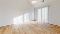 This impressive 2,680 square foot unit in Hartland, WI, offers a blend of modern design and spacious living across two floors. The ground floor, spanning 1,770 sq ft, hosts an open-concept kitchen and living area. The kitchen boasts sleek white cabinetry, stainless steel appliances, and a generous island with a granite countertop. Light oak flooring runs throughout, creating a warm, cohesive look.

The bedroom, measuring 160 sq ft, features high ceilings and large windows that flood the space with natural light. A sliding barn door adds a touch of rustic charm. The bathroom is equipped with a modern vanity and a large glass-enclosed shower.

The unit's design emphasizes brightness and openness, with multiple windows and glass doors leading to a balcony. High ceilings and recessed lighting further enhance the airy feel. A laundry area and ample closet space provide practical amenities.

The second floor, at 910 sq ft, offers additional living space, potentially serving as a home office or recreational area. Two staircases connect the floors, ensuring easy navigation throughout this expansive home. With its thoughtful layout and contemporary finishes, this unit offers a perfect blend of style and functionality.