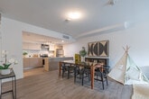 Located at 100 Manett Crescent in Brampton, Ontario, this two-storey home offers a thoughtfully designed layout spread across two floors. The main floor features an open-concept living, dining, and kitchen area finished with light hardwood-style flooring throughout. The kitchen is well-appointed with flat-front cabinetry in a warm grey tone, a subway tile backsplash, stainless steel appliances including a fridge, stove, and dishwasher, and a light stone-finish countertop with an integrated sink. The living area provides generous space, with a staircase featuring a classic white balustrade leading to the upper floor. Upstairs, the primary bedroom is a calm, neutral retreat complete with a built-in closet and hardwood-style flooring. The second bedroom offers comfortable space for guests or family members. Both bathrooms are clean and modern, with one featuring a soaker tub surrounded by elegant marble-effect tile. A dedicated in-unit laundry area with a stacked washer and dryer adds everyday convenience. The home's consistent use of light tones, clean lines, and modern finishes creates a bright, cohesive aesthetic throughout.