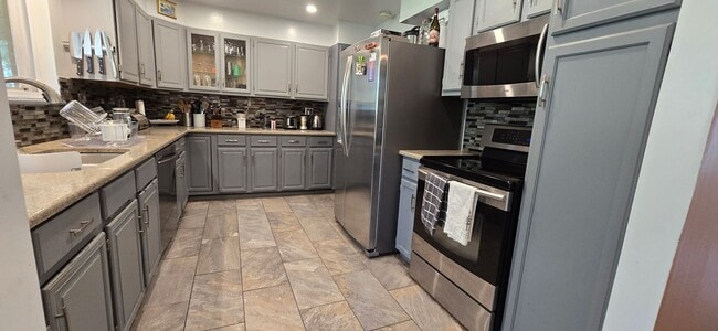 Photo - Spacious Ranch-Style 5BR Home w/ Finished Basement & Large Fenced Yard