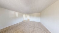 Located at 3255 Gateway St in Springfield, Oregon, this 2-bedroom, 1-bathroom home offers a clean, efficiently designed single-floor layout. The living room is spacious and bright, featuring soft wall-to-wall carpeting, crisp white walls, and a textured ceiling that carries throughout the home. A built-in shelving nook adds a functional decorative touch, while an opening connects the living area to the rest of the home for a natural flow.

The kitchen is well-appointed with white cabinetry, light stone-look countertops, a double-basin sink, and white appliances including a dishwasher, range, and refrigerator. Light wood-look flooring and a modern ceiling fan add warmth and practicality. A sliding glass door provides direct access to the outdoors, bringing in natural light.

Both bedrooms are carpeted and finished with neutral tones, offering a comfortable and versatile space. The primary bedroom includes a mirrored sliding closet door, and windows in each room bring in natural light with outdoor views. Four closets throughout the home ensure generous storage.

The bathroom features a white vanity with marble-look countertop, a lighted mirror, wood-look flooring, and a clean, bright finish. Overall, this home presents a tidy, move-in-ready aesthetic with a practical and cohesive design.