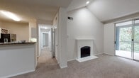 Located at 3355 McDaniel Rd in Duluth, GA, this 2-bedroom, 1-bathroom residence offers a well-designed single-floor layout with a range of notable features throughout. The living room serves as the heart of the home, boasting dramatic vaulted ceilings, a white-mantled wood-burning fireplace, and a sliding glass door that opens to a private balcony overlooking lush greenery — filling the space with natural light and a sense of openness. Plush carpeting extends through the living areas and both bedrooms, contributing to a comfortable, warm ambiance. The kitchen is thoughtfully equipped with white cabinetry, dark granite-style countertops, stainless steel appliances including a range and refrigerator, and durable wood-look flooring. A built-in wine rack adds a functional decorative touch. The full bathroom features matching white cabinetry, granite-style countertops, wood-look flooring, and a tiled soaking tub. Both bedrooms are generously sized, each with ceiling fans, ample closet space, and windows that invite natural light and treetop views. A hallway with louvered closet doors provides additional storage. The overall aesthetic is clean, neutral, and move-in ready.