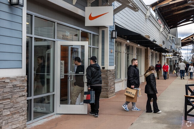 Shoppers browse stores at Merrimack Premium Outlets in Merrimack, New Hampshire.